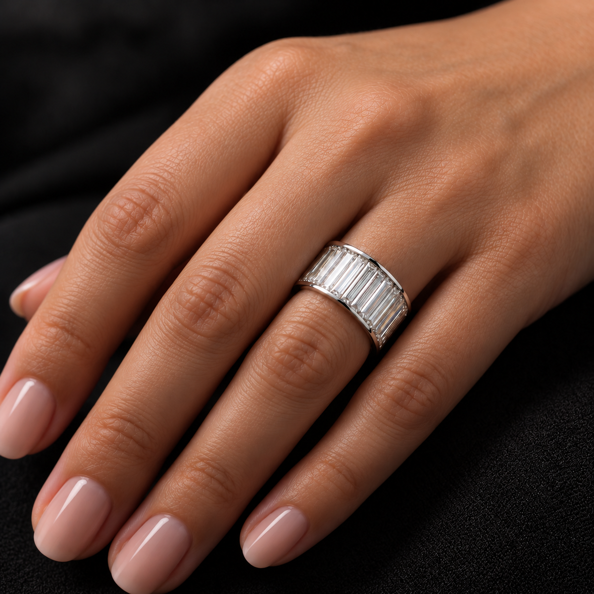 Platinum baguette diamond eternity band shown on a hand